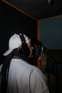 a woman wearing headphones in a recording studio